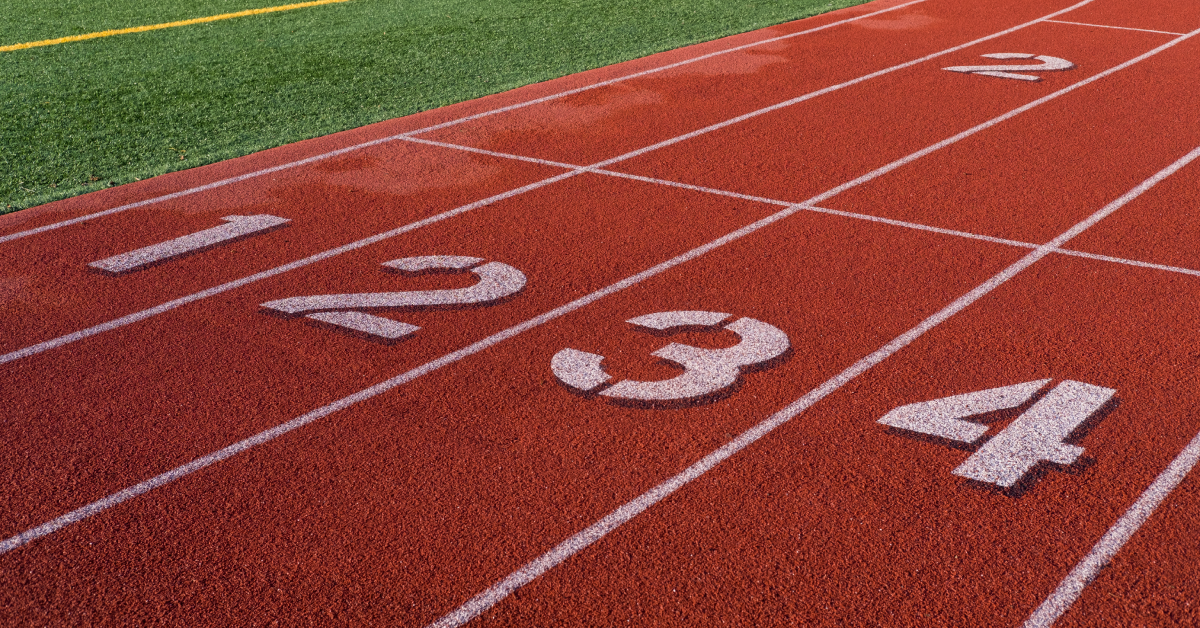 A race track with four lanes that are numbered. 