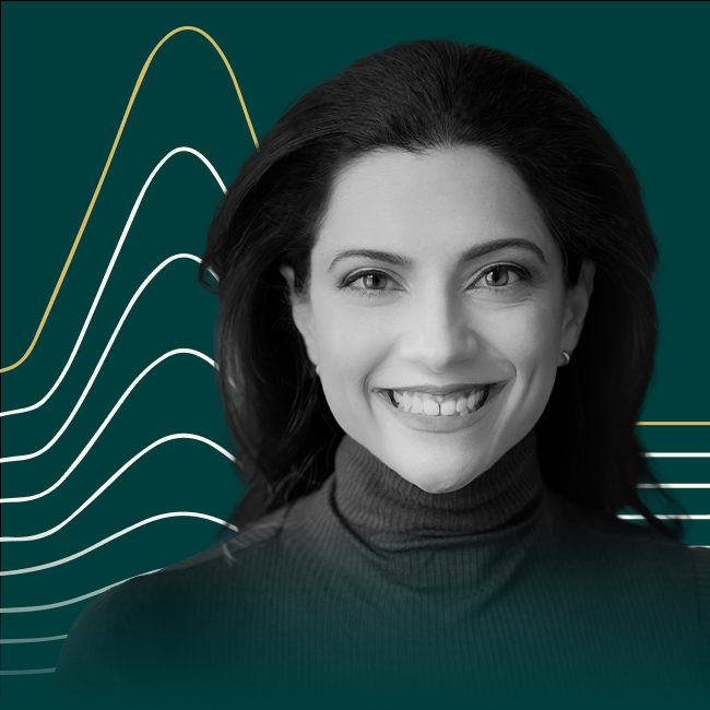 Reshma Saujani headshot on a forest green background. 